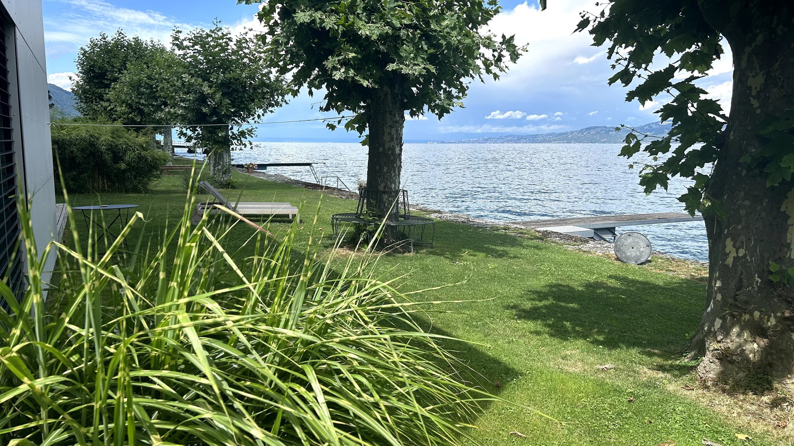 The garden runs down to the shore